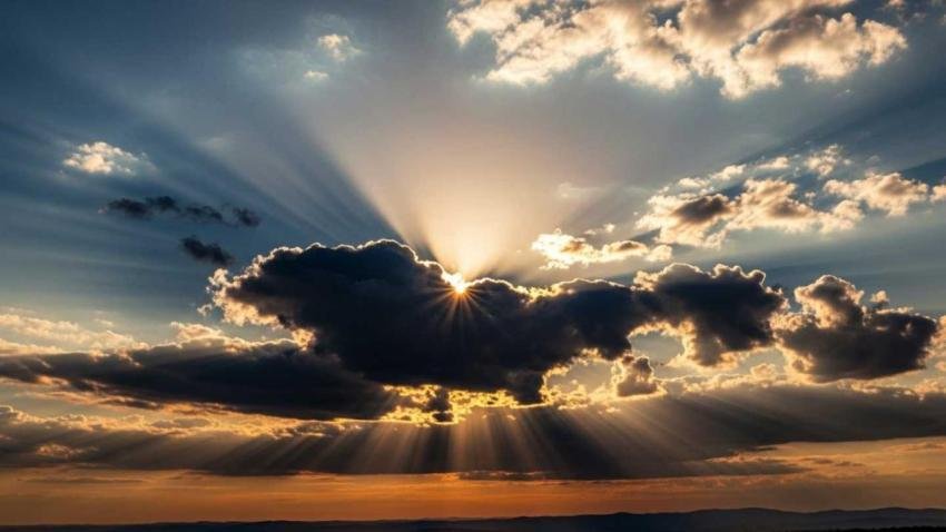 Cloudscape with sun rays breaking through computer background