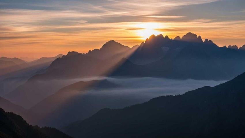 Sunrise over misty mountains background